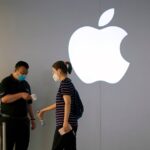 A woman wearing a protective face mask waits to measure her temperature in an Apple Store following the coronavirus disease (COVID-19) outbreak, in Shanghai