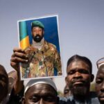 Supporters-of-Januarys-coup-in-Burkina-Faso-wave-a-photo-of-the-leader-of-Mali-who-also-took-power-by-coup-last-year