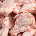"Chicken wings, frozen. Horizontal studio shot, full frame."