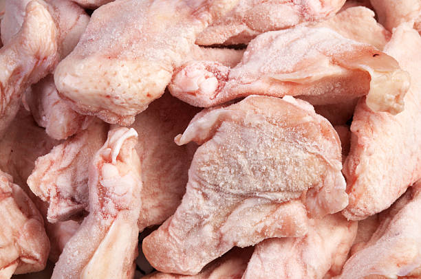 "Chicken wings, frozen. Horizontal studio shot, full frame."